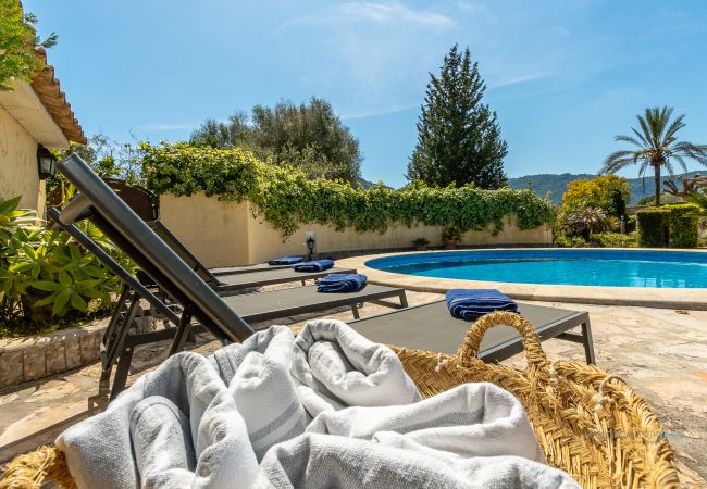 Piscina con tumbonas de La Sort Llarga en Pollença Piscina privada redonda con varias tumbonas y toallas listas para los huéspedes en La Sort Llarga, Pollença
