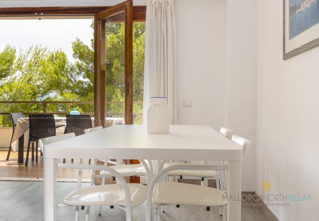 Essbereich an der Terrasse Weißer Esstisch neben offenen Türen zur Terrasse